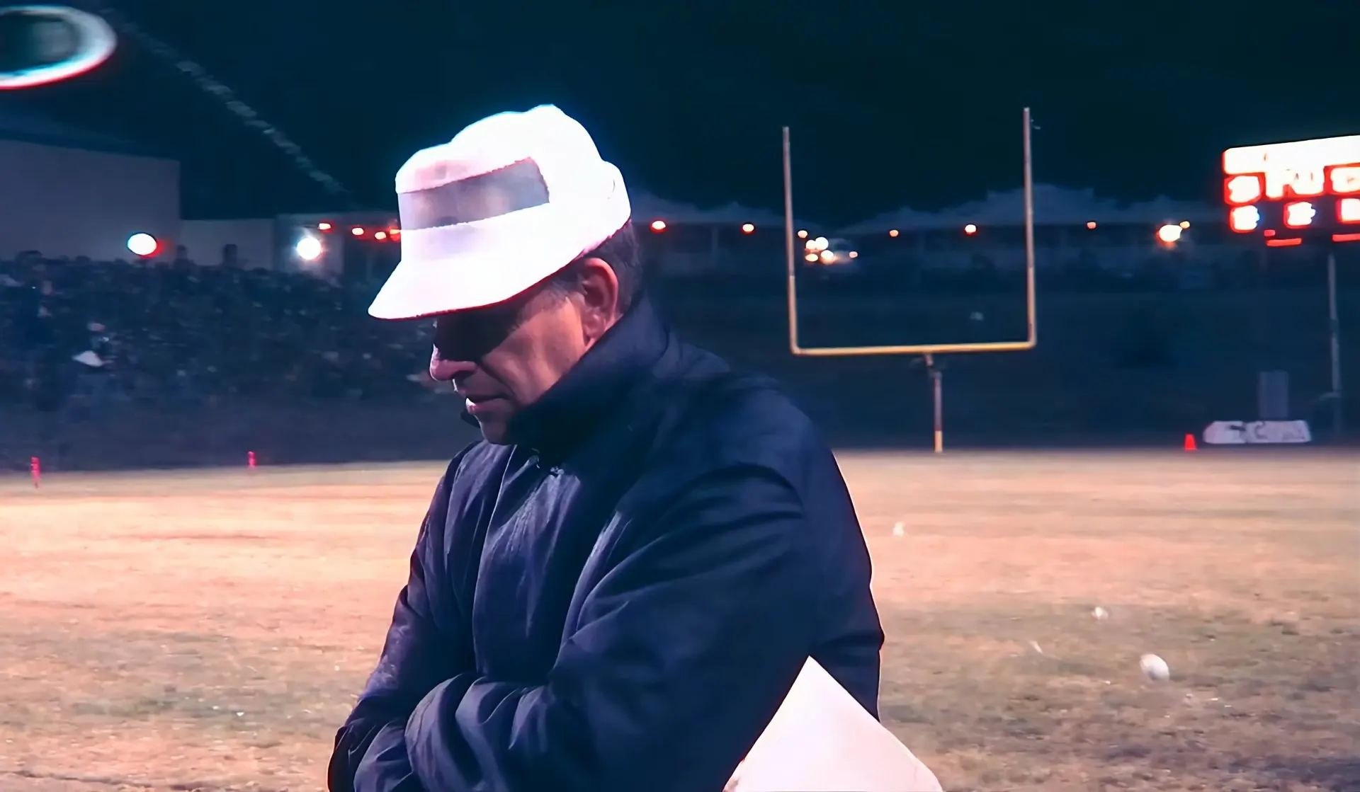 Coach Mooney Player on the sideline at night